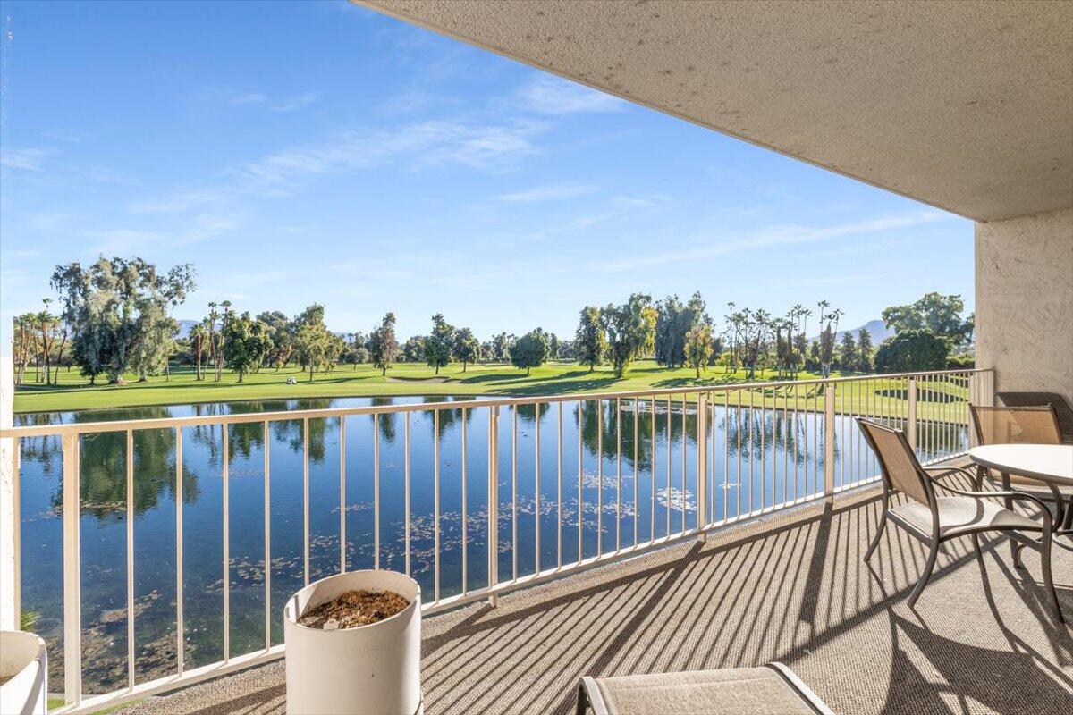 900 Island Drive, Unit 313 Rancho Mirage, CA 92270 - Photo 33 of 62 a view of a balcony with wooden floor and outdoor seating
