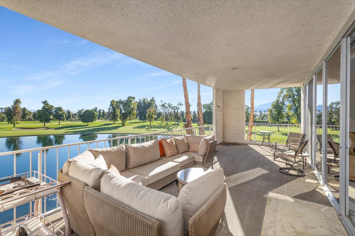 900 Island Drive, Unit 313 Rancho Mirage, CA 92270 - Photo 40 of 62 a living room with furniture and a floor to ceiling window