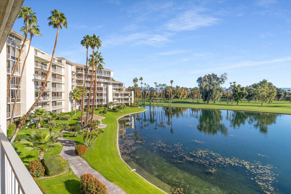 900 Island Drive, Unit 313 Rancho Mirage, CA 92270 - Photo 42 of 62 a view of a lake with a building in the background