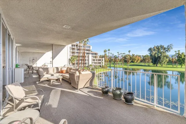 a view of a swimming pool with outdoor seating