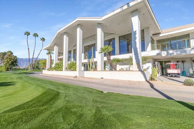a view of a swimming pool with a yard and a fountain