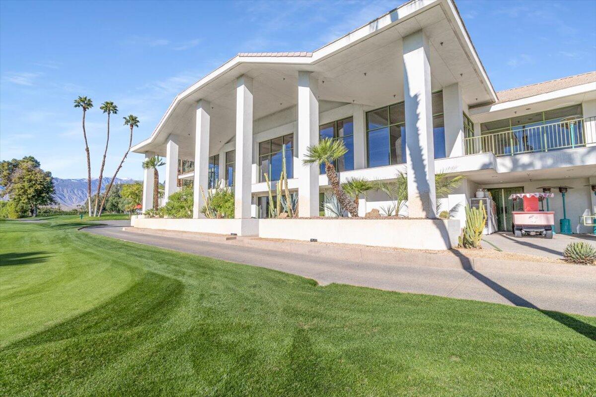 900 Island Drive, Unit 313 Rancho Mirage, CA 92270 - Photo 49 of 62 a view of a building with a yard