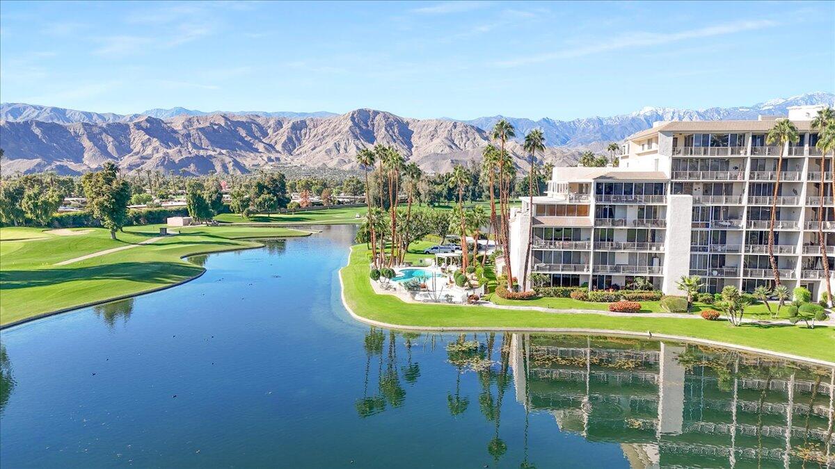 900 Island Drive, Unit 313 Rancho Mirage, CA 92270 - Photo 58 of 62 a view of a swimming pool with a patio and a big yard