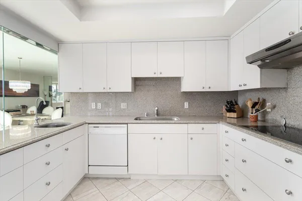 a kitchen with stainless steel appliances white cabinets and a sink