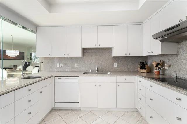 a kitchen with stainless steel appliances white cabinets and a sink