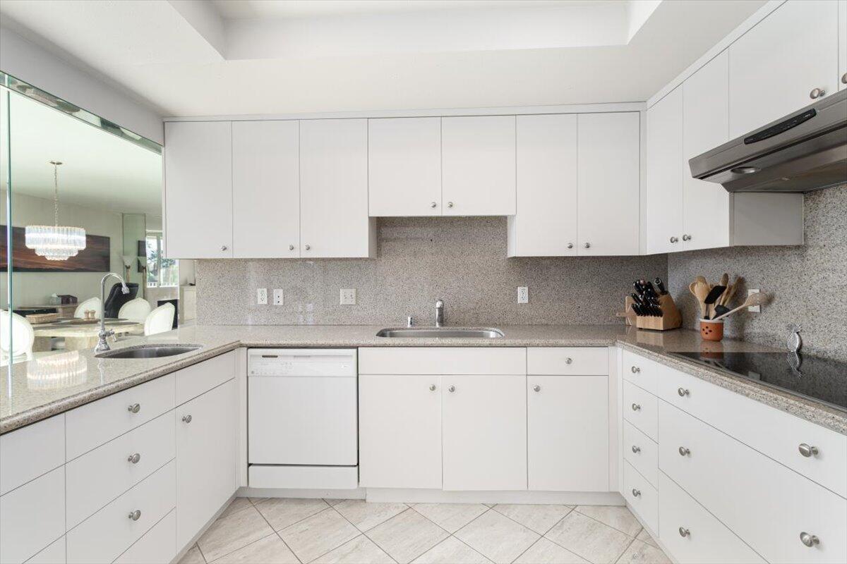 900 Island Drive, Unit 313 Rancho Mirage, CA 92270 - Photo 7 of 62 a kitchen with granite countertop white cabinets white stainless steel appliances and sink