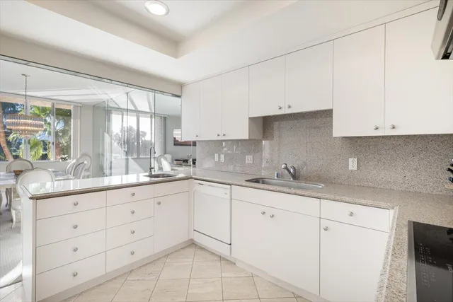 a kitchen with stainless steel appliances granite countertop a sink refrigerator and cabinets
