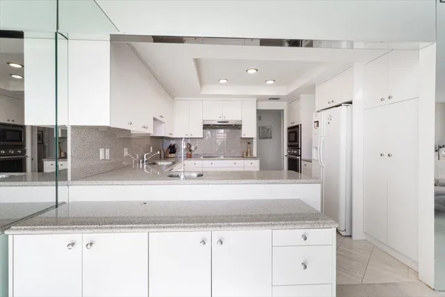 a dining room with furniture a chandelier and window