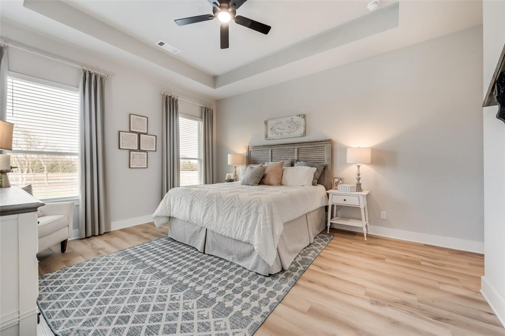 250 Brown Road Leonard, TX 75452 - Photo 29 of 29 Tray ceiling with a black ceiling fan, wood-finish flooring, and multiple windows