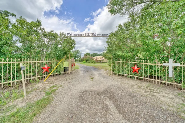 a view of park with iron fence