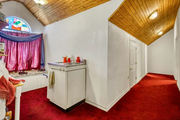 a bed room with a bed and a chandelier