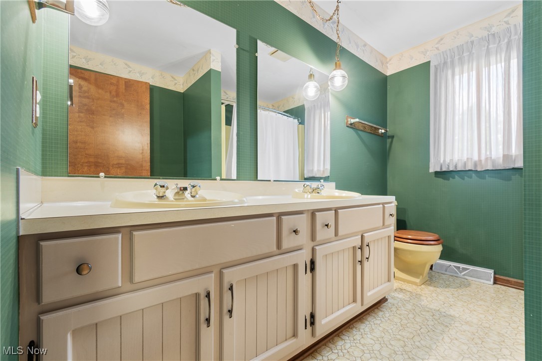 2317 Raintree Street Northeast Canton, OH 44705 - Photo 28 of 40 Bathroom featuring wallpapered walls, double vanity, and a shower with shower curtain