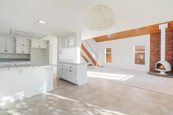 a kitchen with stainless steel appliances kitchen island granite countertop a sink and cabinets