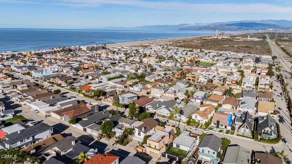 an aerial view of a city with lots of residential buildings and parking space