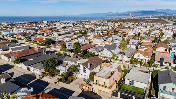 an aerial view of a house with a yard