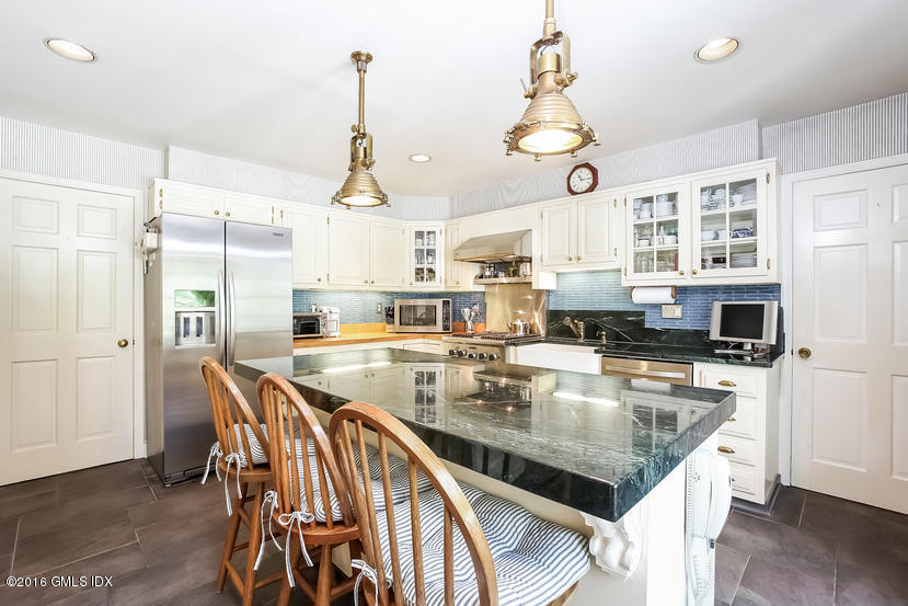 144 Cat Rock Road Cos Cob, CT 06807 - Photo 8 of 20 a kitchen with stainless steel appliances granite countertop a kitchen island a stove a table and chairs