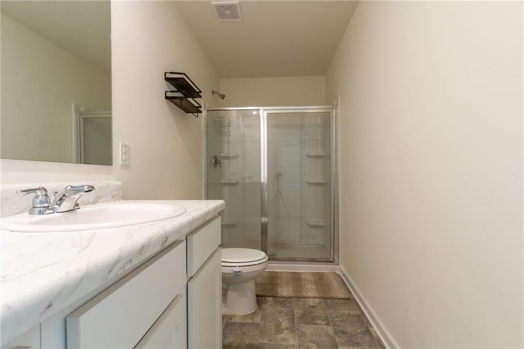 4282 Callum Court Decatur, GA 30034 - Photo 17 of 29 a bathroom with a granite countertop sink a toilet and shower