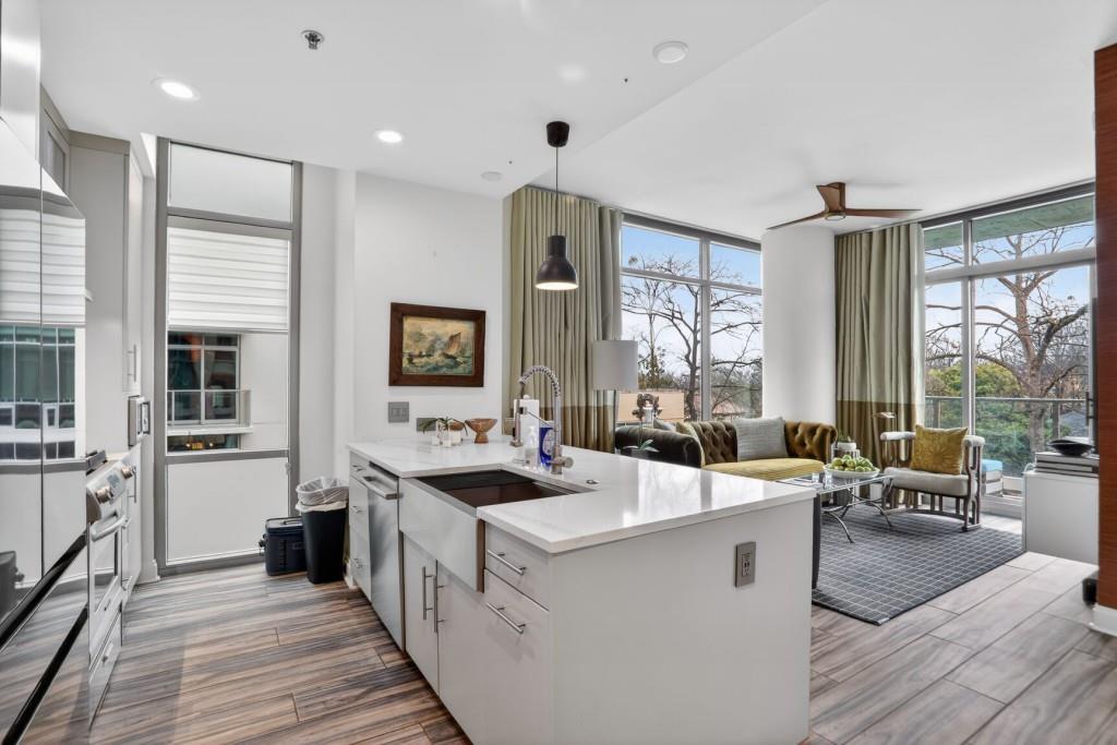 905 Juniper Street Northeast, Unit 403 Atlanta, GA 30309 - Photo 1 of 21 a large white kitchen with a large window and furniture