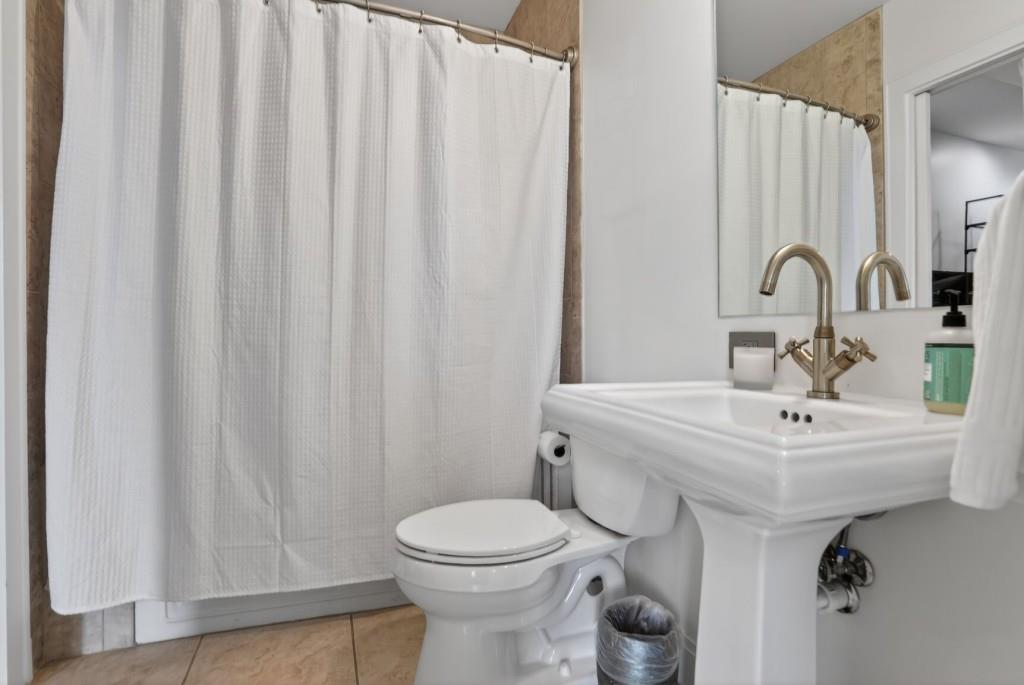 905 Juniper Street Northeast, Unit 403 Atlanta, GA 30309 - Photo 12 of 21 a bathroom with a sink toilet and a mirror
