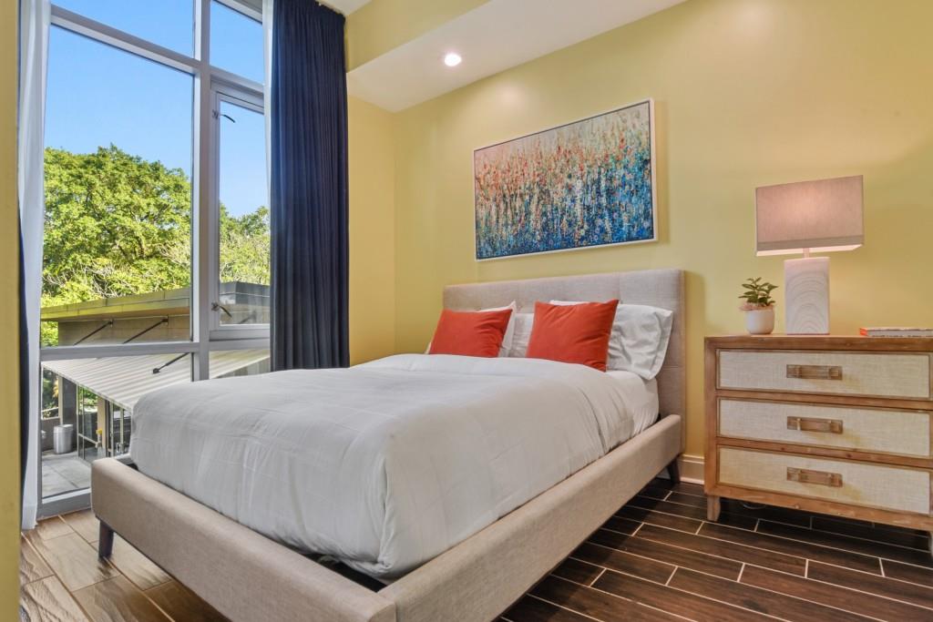 905 Juniper Street Northeast, Unit 403 Atlanta, GA 30309 - Photo 15 of 21 a bedroom with a bed and a window