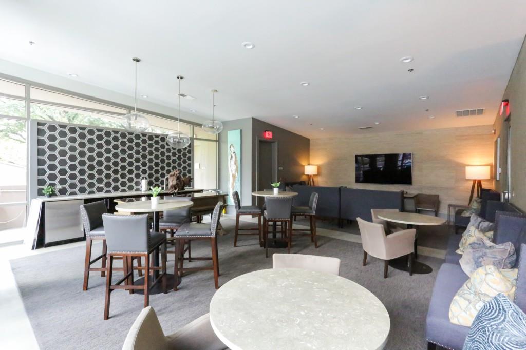 905 Juniper Street Northeast, Unit 403 Atlanta, GA 30309 - Photo 18 of 21 a living room with furniture a flat screen tv and a table