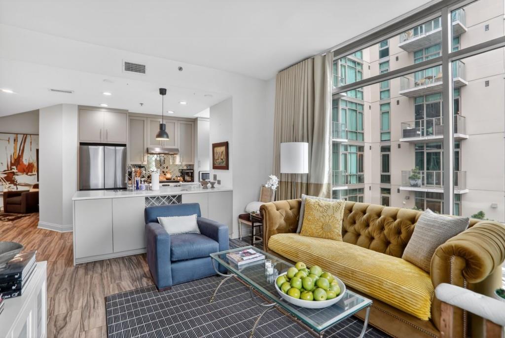 905 Juniper Street Northeast, Unit 403 Atlanta, GA 30309 - Photo 5 of 21 a living room with furniture and a large window
