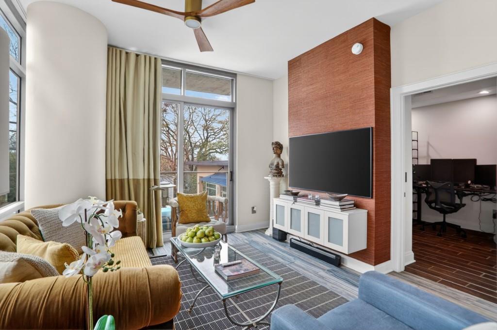 905 Juniper Street Northeast, Unit 403 Atlanta, GA 30309 - Photo 6 of 21 a living room with furniture and a flat screen tv