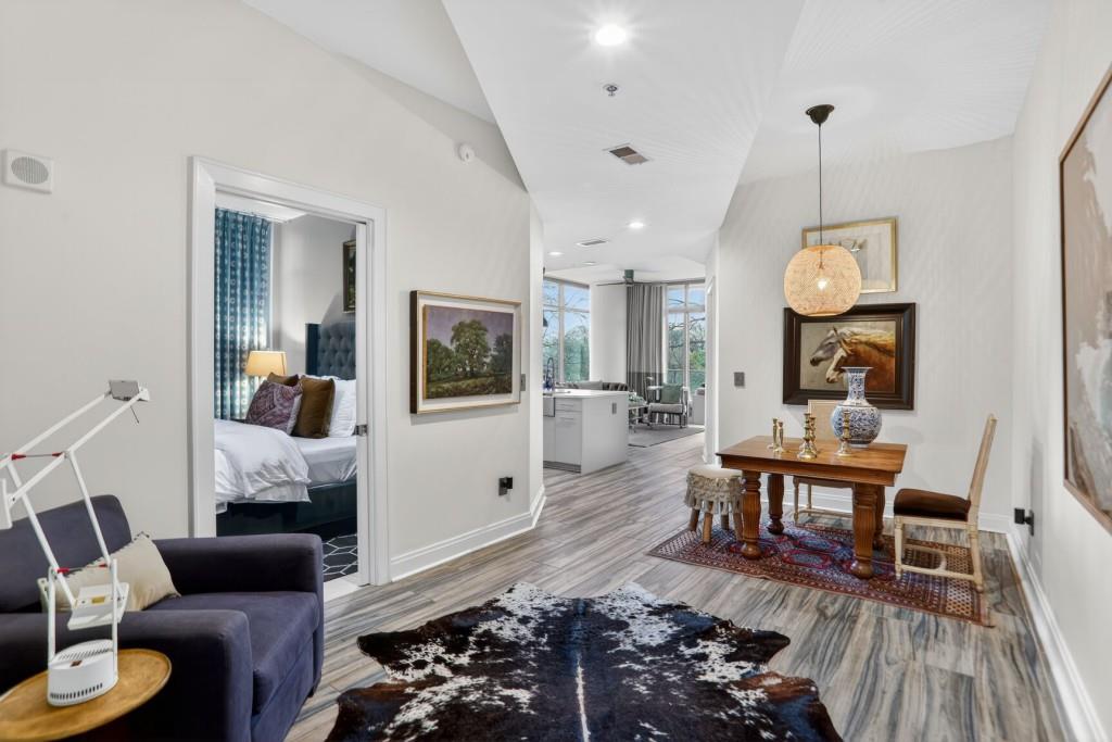 905 Juniper Street Northeast, Unit 403 Atlanta, GA 30309 - Photo 7 of 21 a living room with furniture and a wooden floor
