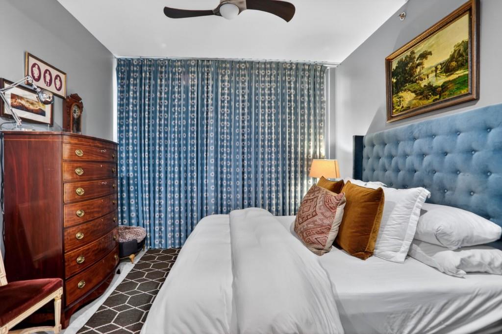 905 Juniper Street Northeast, Unit 403 Atlanta, GA 30309 - Photo 8 of 21 a bedroom with a bed and a painting on the wall