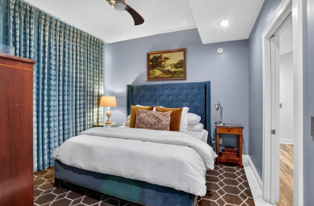 905 Juniper Street Northeast, Unit 403 Atlanta, GA 30309 - Photo 9 of 21 a bedroom with a bed and window