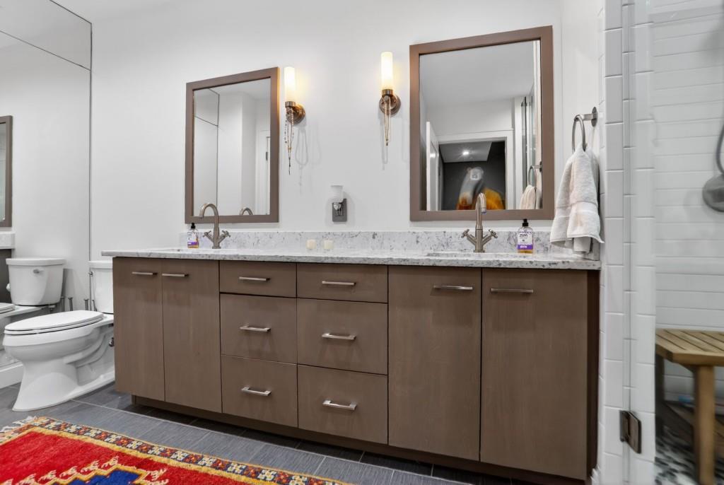 905 Juniper Street Northeast, Unit 403 Atlanta, GA 30309 - Photo 10 of 21 a bathroom with a granite countertop sink toilet and mirror
