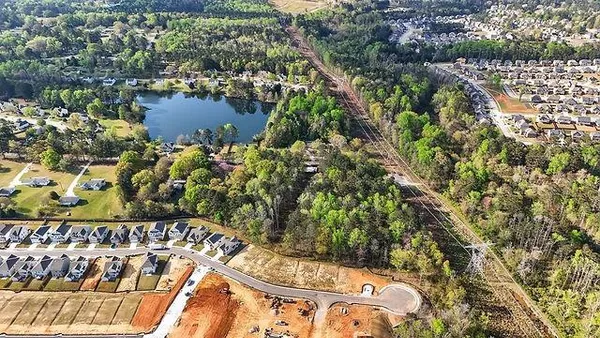 an aerial view of lake and residential houses with outdoor space