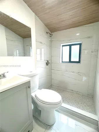 a bathroom with a toilet sink and shower