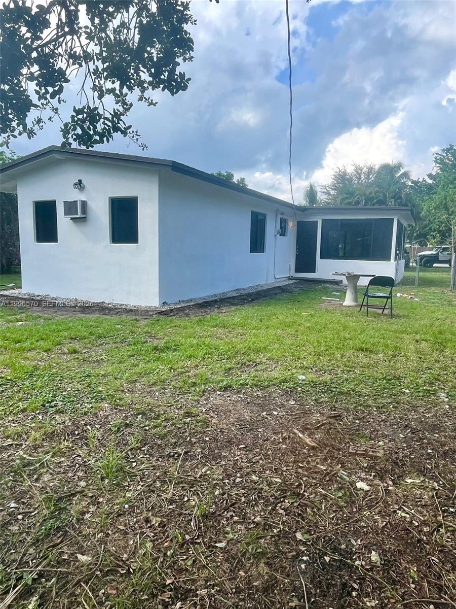 1776 Northeast 178th Street Miami, FL 33162 - Photo 17 of 18 a backyard of a house with table and chairs