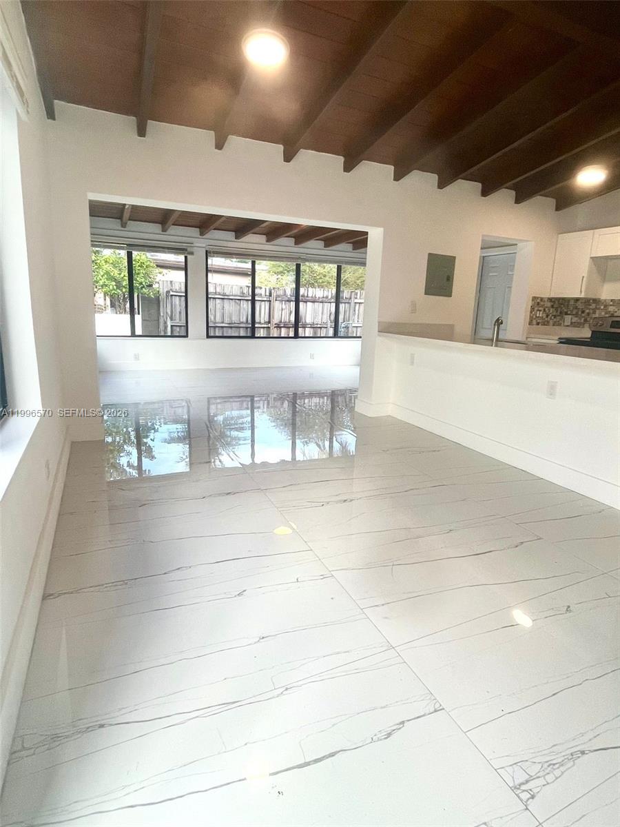 1776 Northeast 178th Street Miami, FL 33162 - Photo 3 of 18 a living room with a couch