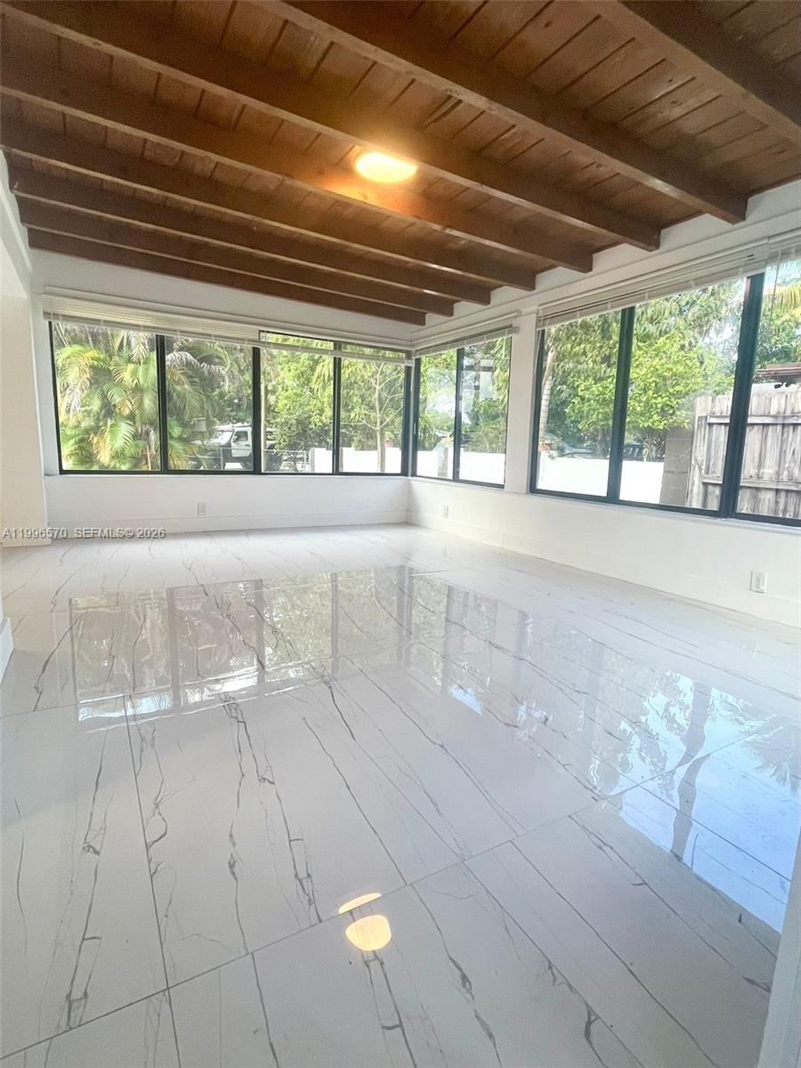 1776 Northeast 178th Street Miami, FL 33162 - Photo 6 of 18 a view of an empty room with a window