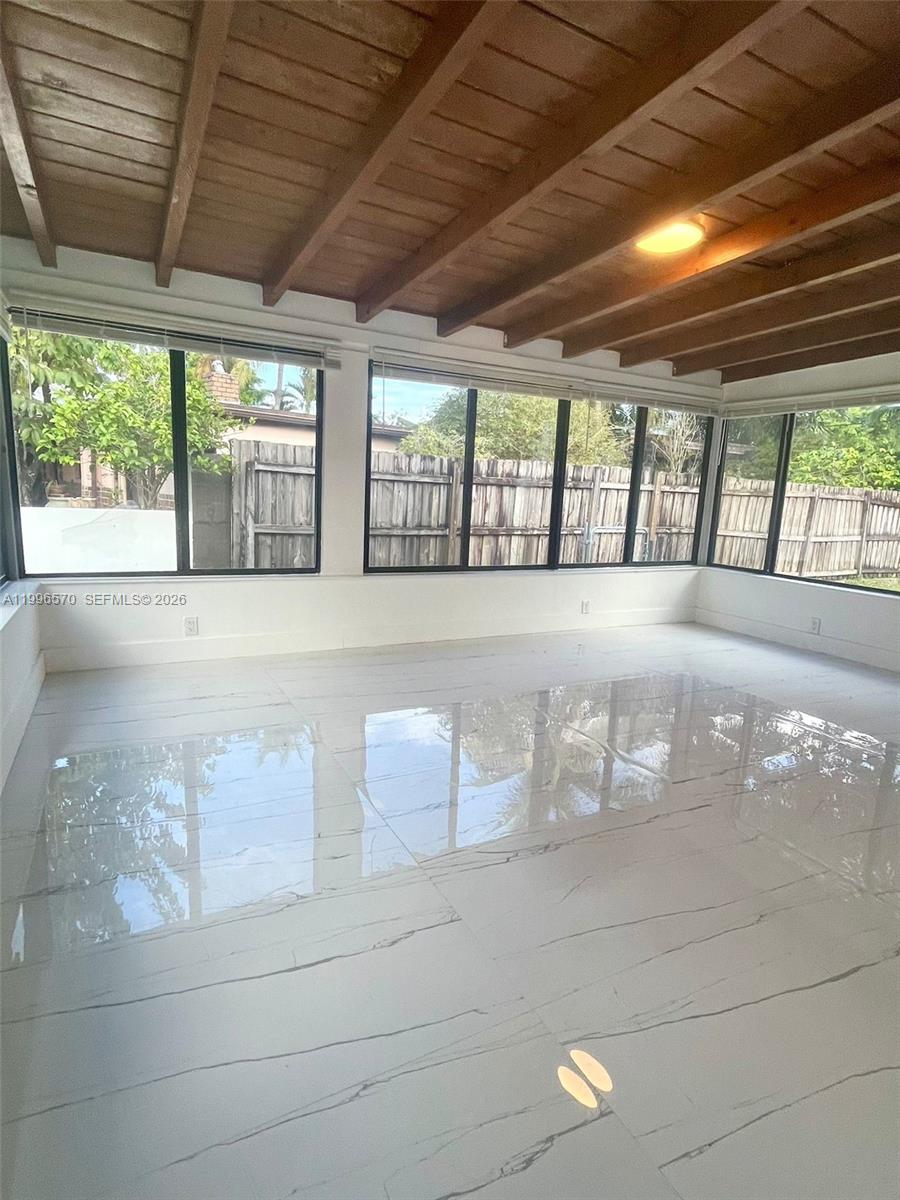 1776 Northeast 178th Street Miami, FL 33162 - Photo 7 of 18 a view of an empty room with a window