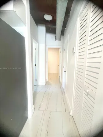 a view of a hallway with a white walls