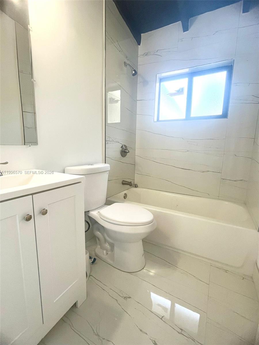 1776 Northeast 178th Street Miami, FL 33162 - Photo 9 of 18 a bathroom with a sink a toilet and shower