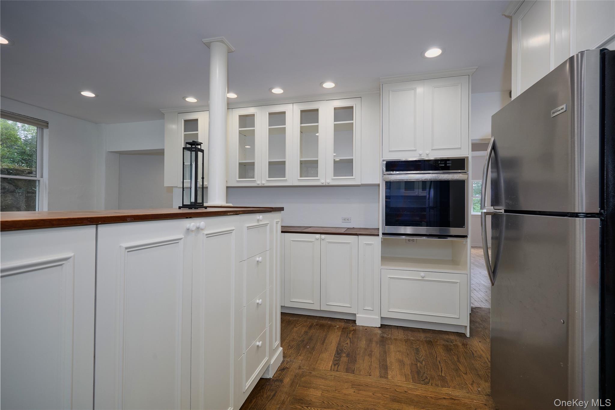 93 Circuit Road Tuxedo Park, NY 10987 - Photo 12 of 34 Kitchen featuring glass insert cabinets, stainless steel appliances, wooden counters, dark wood-style flooring, and recessed lighting