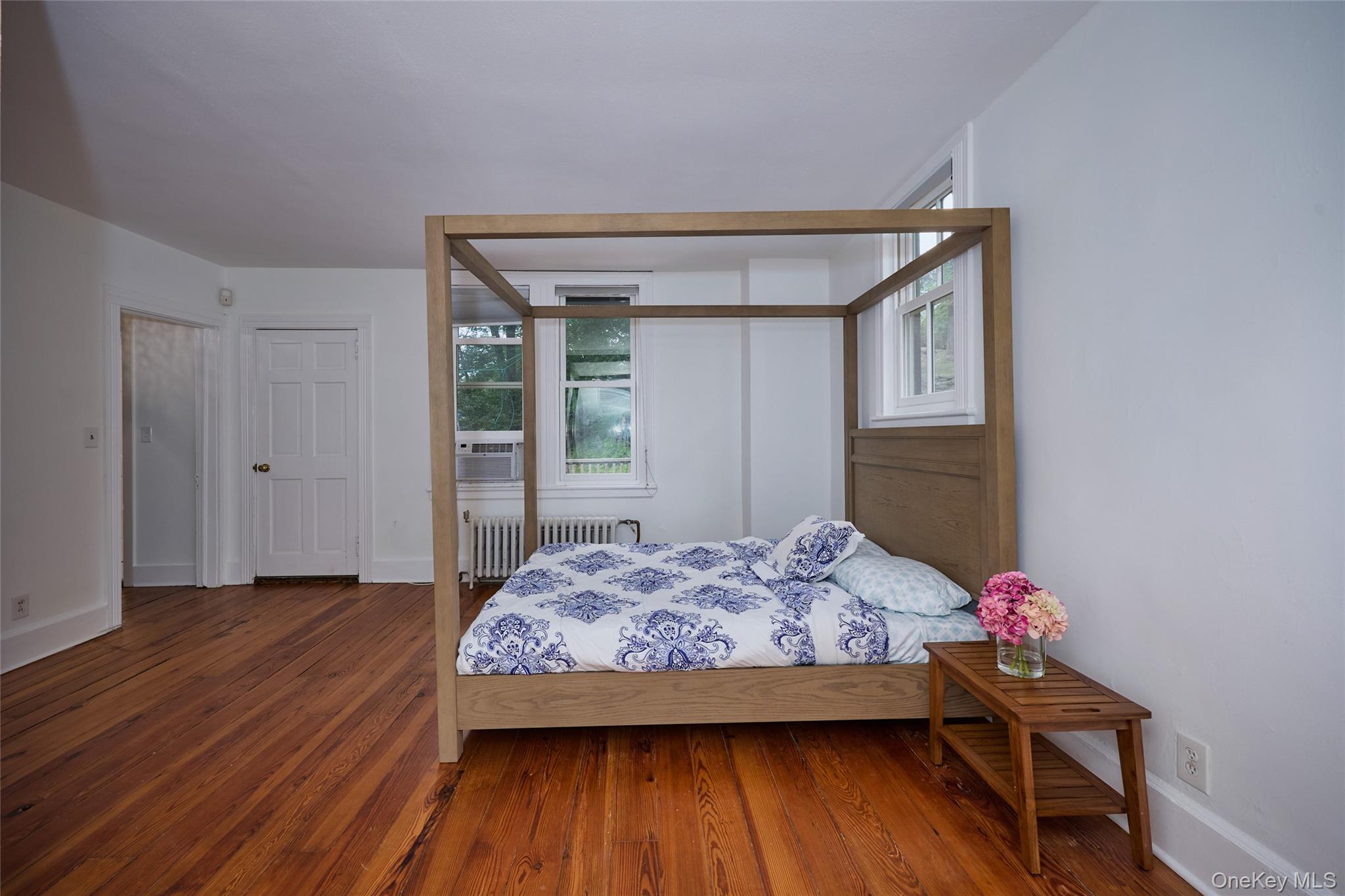 93 Circuit Road Tuxedo Park, NY 10987 - Photo 20 of 34 Bedroom with wood finished floors and radiator heating unit