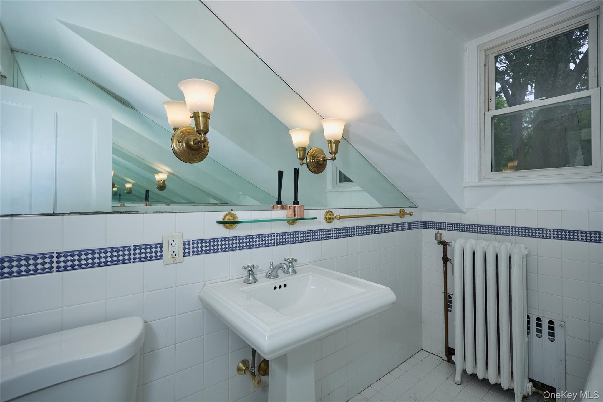 93 Circuit Road Tuxedo Park, NY 10987 - Photo 23 of 34 Half bath featuring radiator heating unit, tile walls, tile patterned floors, and lofted ceiling