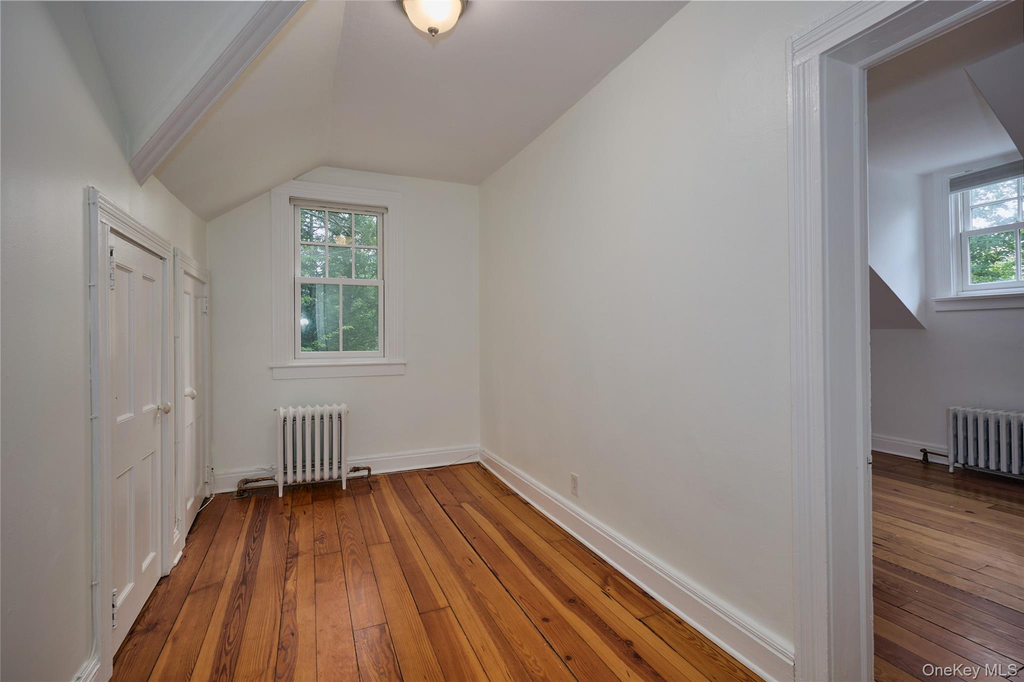 93 Circuit Road Tuxedo Park, NY 10987 - Photo 24 of 34 Additional living space featuring hardwood / wood-style floors, radiator heating unit, and lofted ceiling