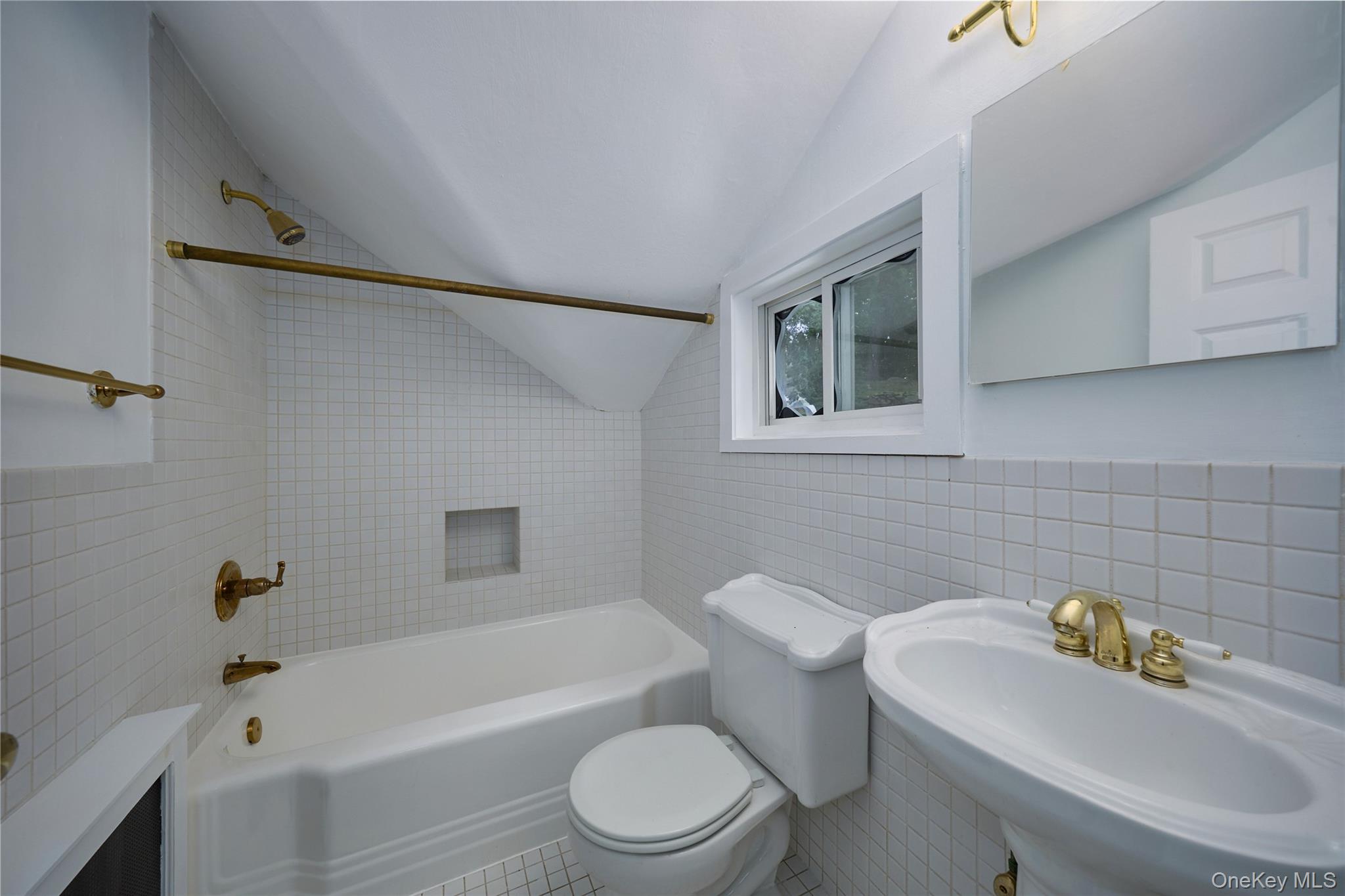 93 Circuit Road Tuxedo Park, NY 10987 - Photo 26 of 34 Bathroom featuring tile walls, washtub / shower combination, and lofted ceiling