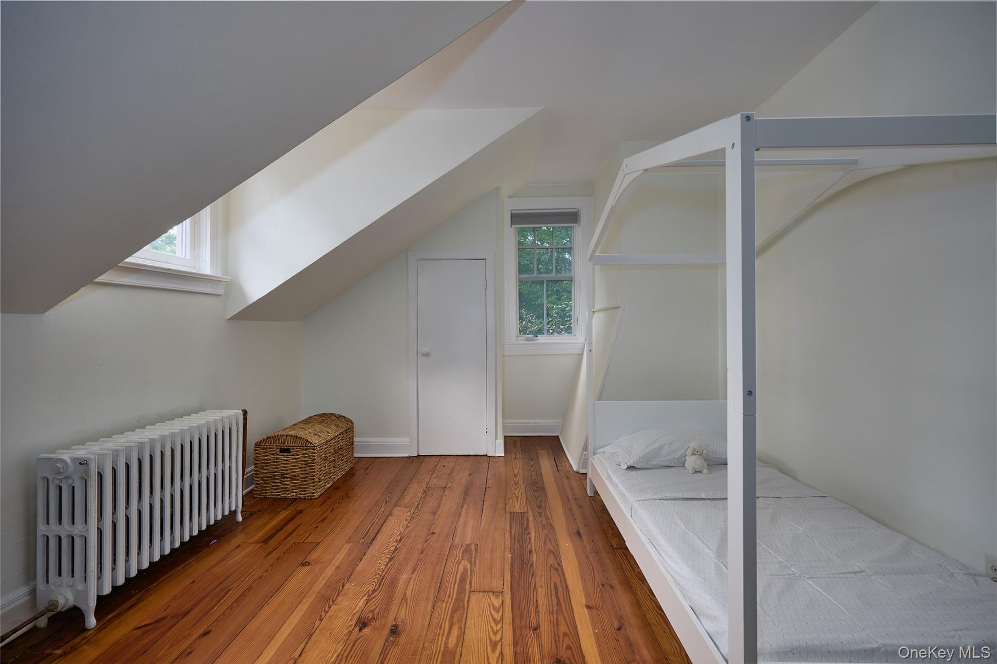 93 Circuit Road Tuxedo Park, NY 10987 - Photo 27 of 34 Bonus room featuring radiator, hardwood / wood-style flooring, plenty of natural light, and lofted ceiling