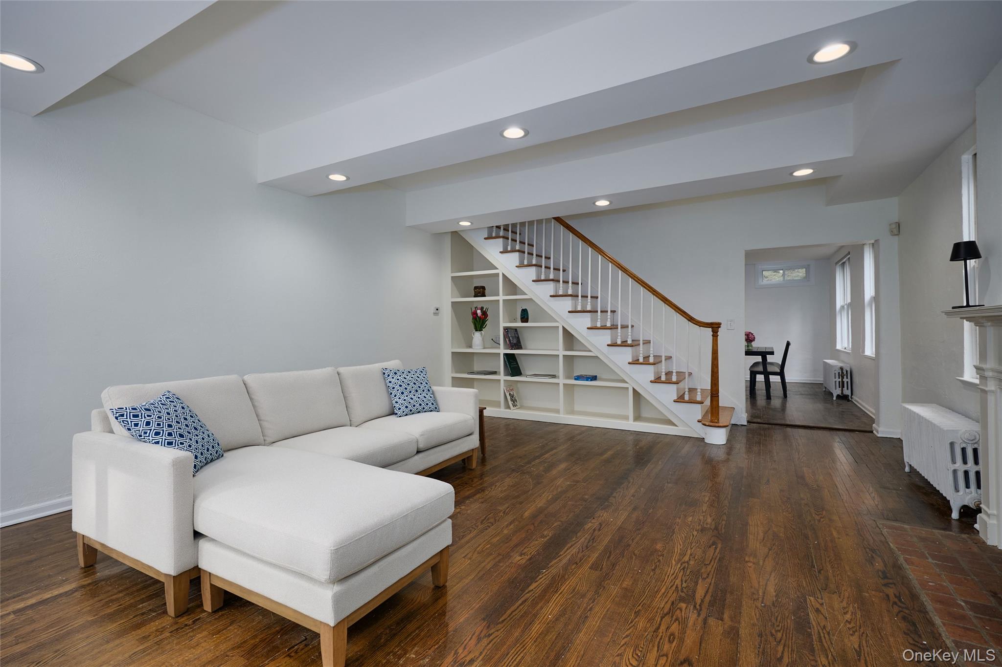 93 Circuit Road Tuxedo Park, NY 10987 - Photo 6 of 34 Living room with recessed lighting, radiator heating unit, dark wood finished floors, and stairs
