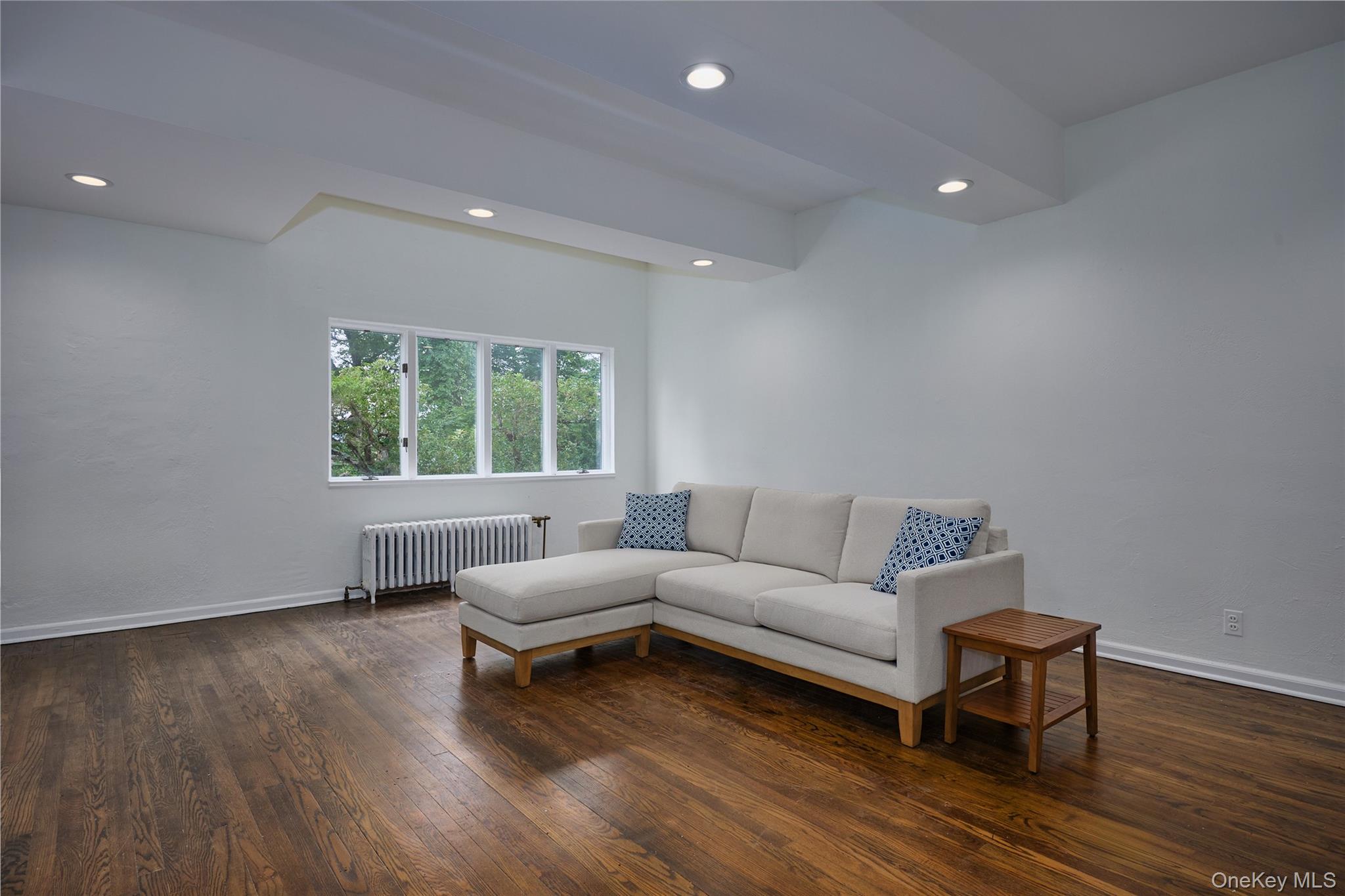 93 Circuit Road Tuxedo Park, NY 10987 - Photo 7 of 34 Living area featuring radiator heating unit, dark wood-style floors, and recessed lighting