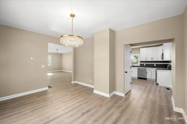 a view of a kitchen with a sink a refrigerator and window