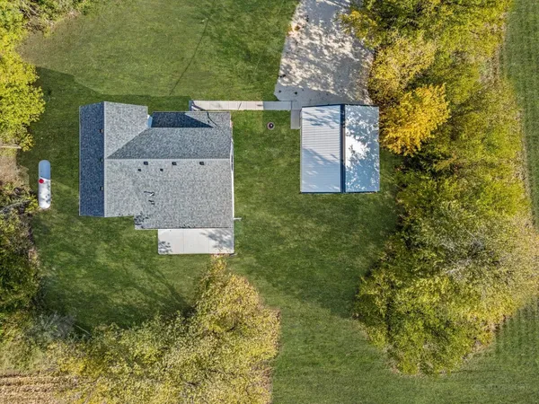an aerial view of a house with a yard