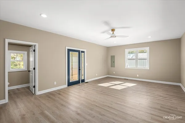 an empty room with window and a ceiling fan